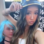 Madysen Vue with long brown hair wearing her German pickelhaube hat is standing next to Whatever Podcast doll with blue hair. Madysen Vue Whatever Podcast Hat Girl Whatever Podcast Guest