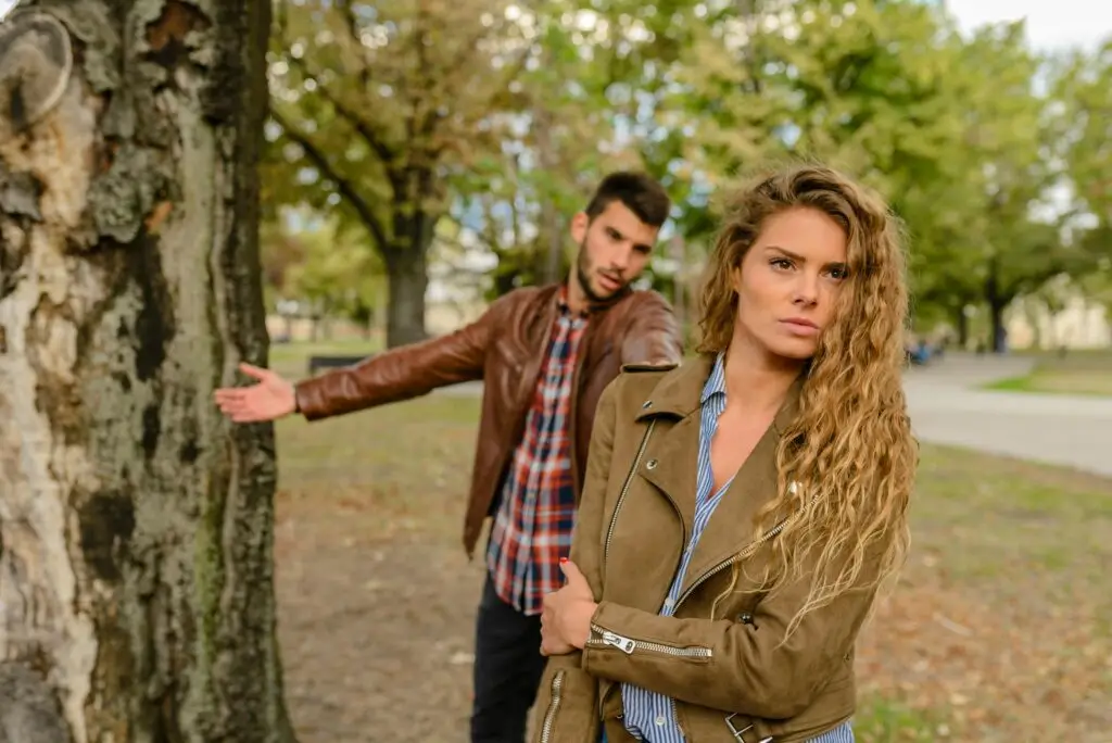 Normalizing Toxic Behavior Woman And Man Wearing Brown Jackets Standing Near Tree. Why Can Bro Code Harm Women